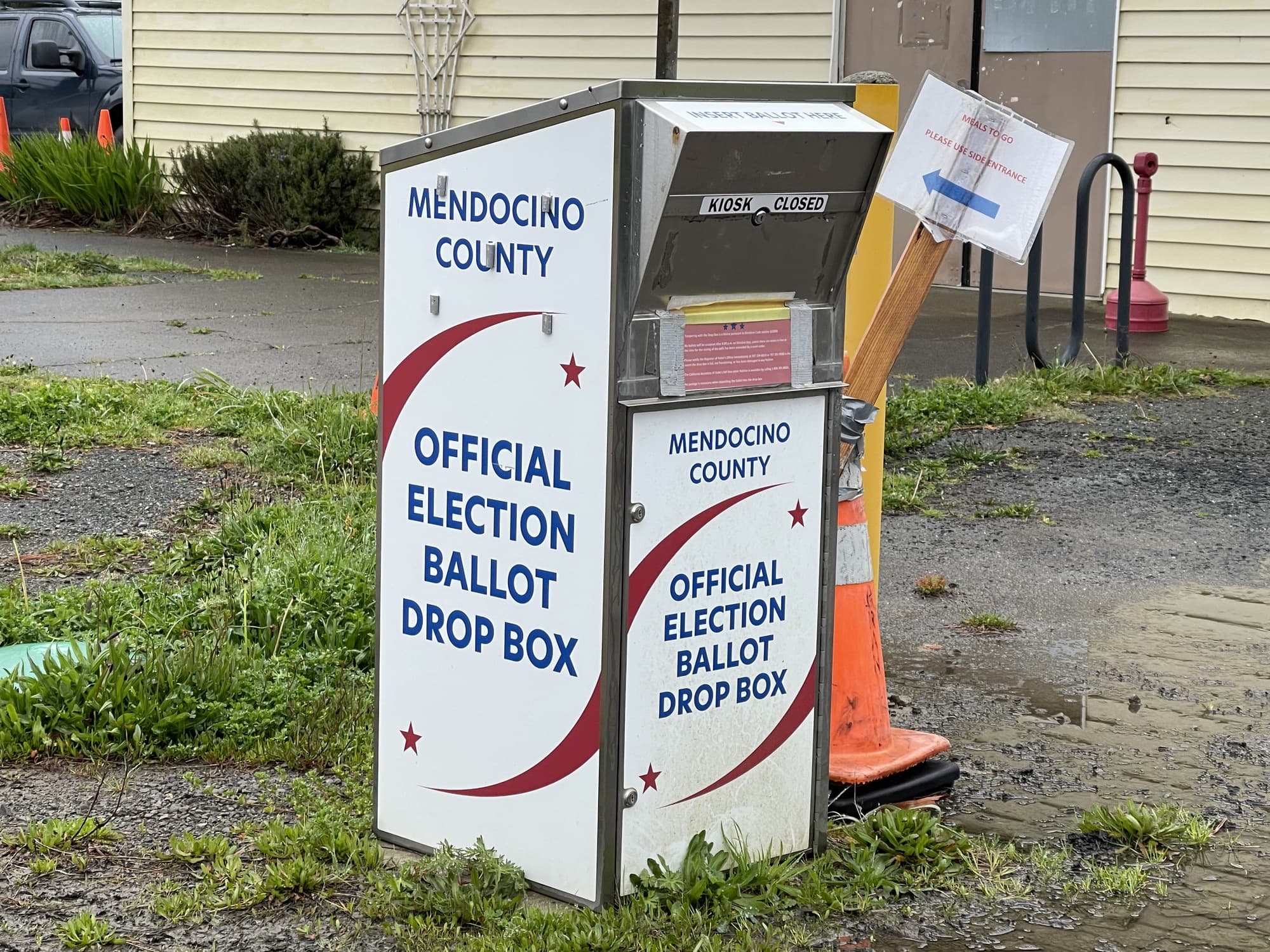 An official Mendocino County election ballot drop box beside a street in Point Arena, California.