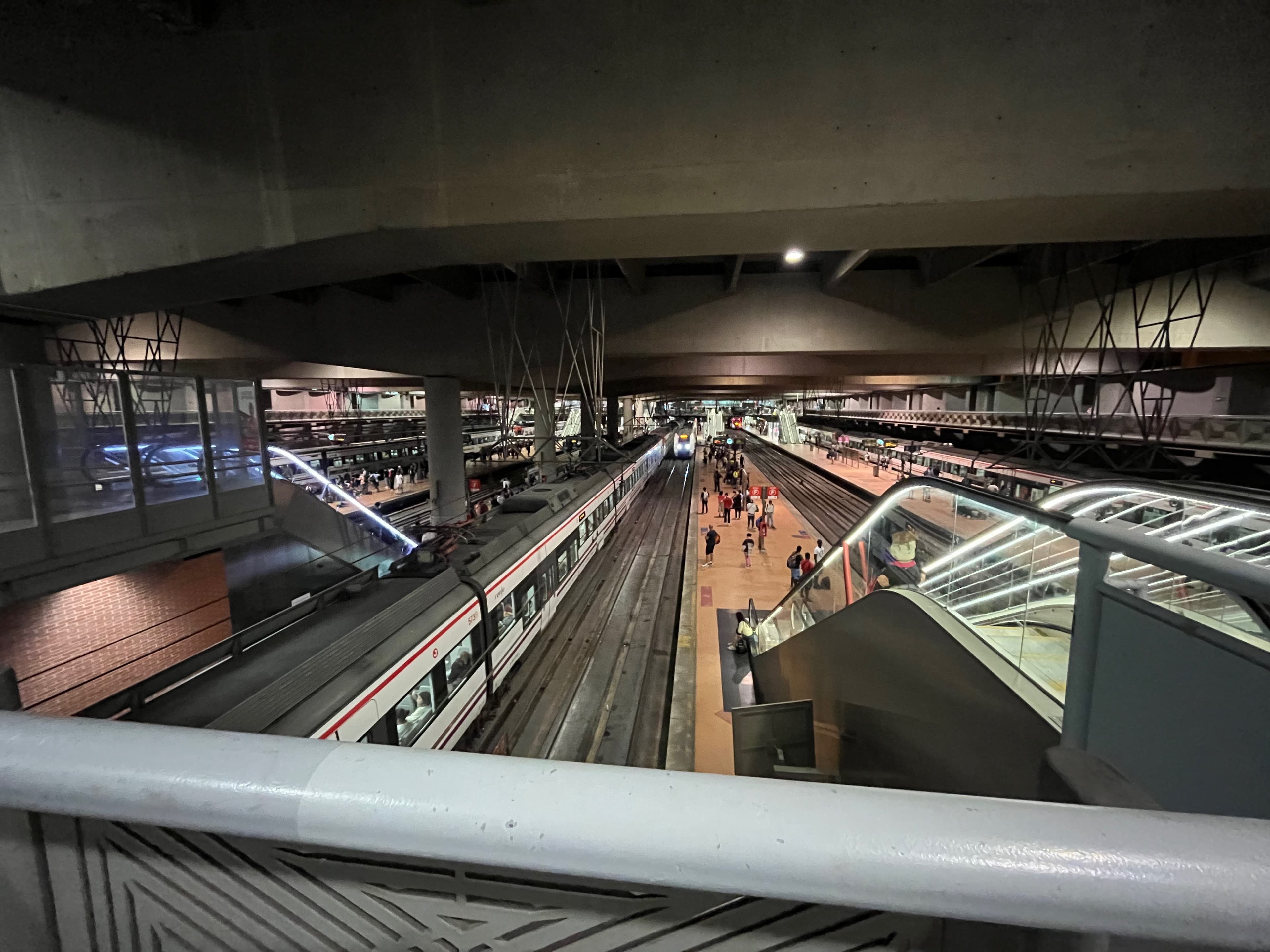 A Renfe commuter train and passengers at Madrid’s Atocha-Cercanías station, viewed from above in an August 28, 2023 photograph.