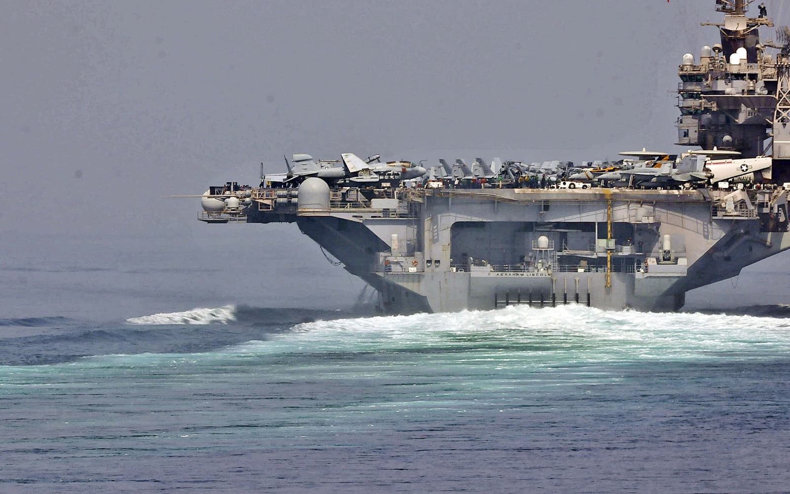 U.S. Navy ships transiting the Strait of Hormuz in May 2012; archive context, not a new military operation.