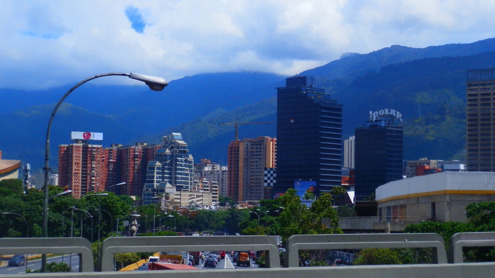 Downtown Caracas skyline with the dark glass tower that houses Venezuela's National Electoral Council headquarters, the Torre Polar and the Avila mountain behind, in a 2012 archive photo.